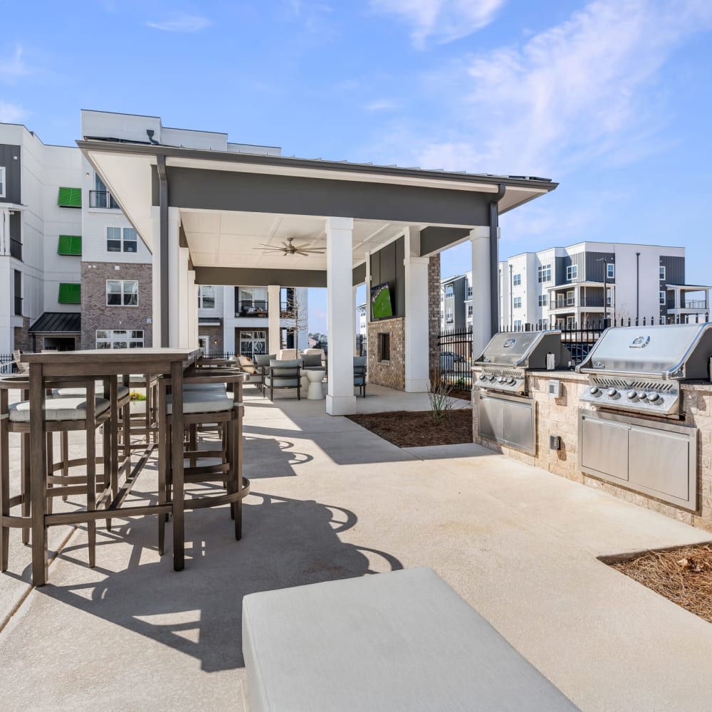 An outdoor grilling area by the pool at The Station at Clift Farm in Madison, Alabama