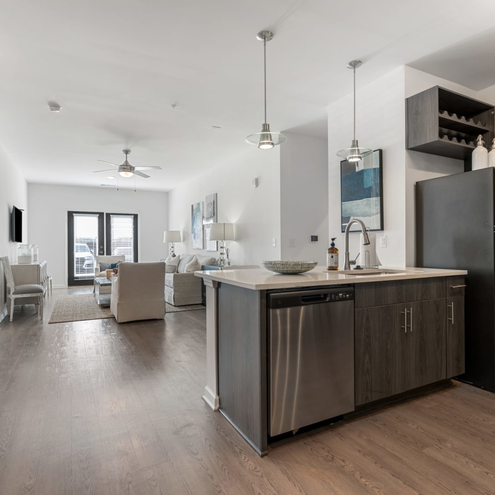 An apartment kitchen and living room at The Station at Clift Farm in Madison, Alabama