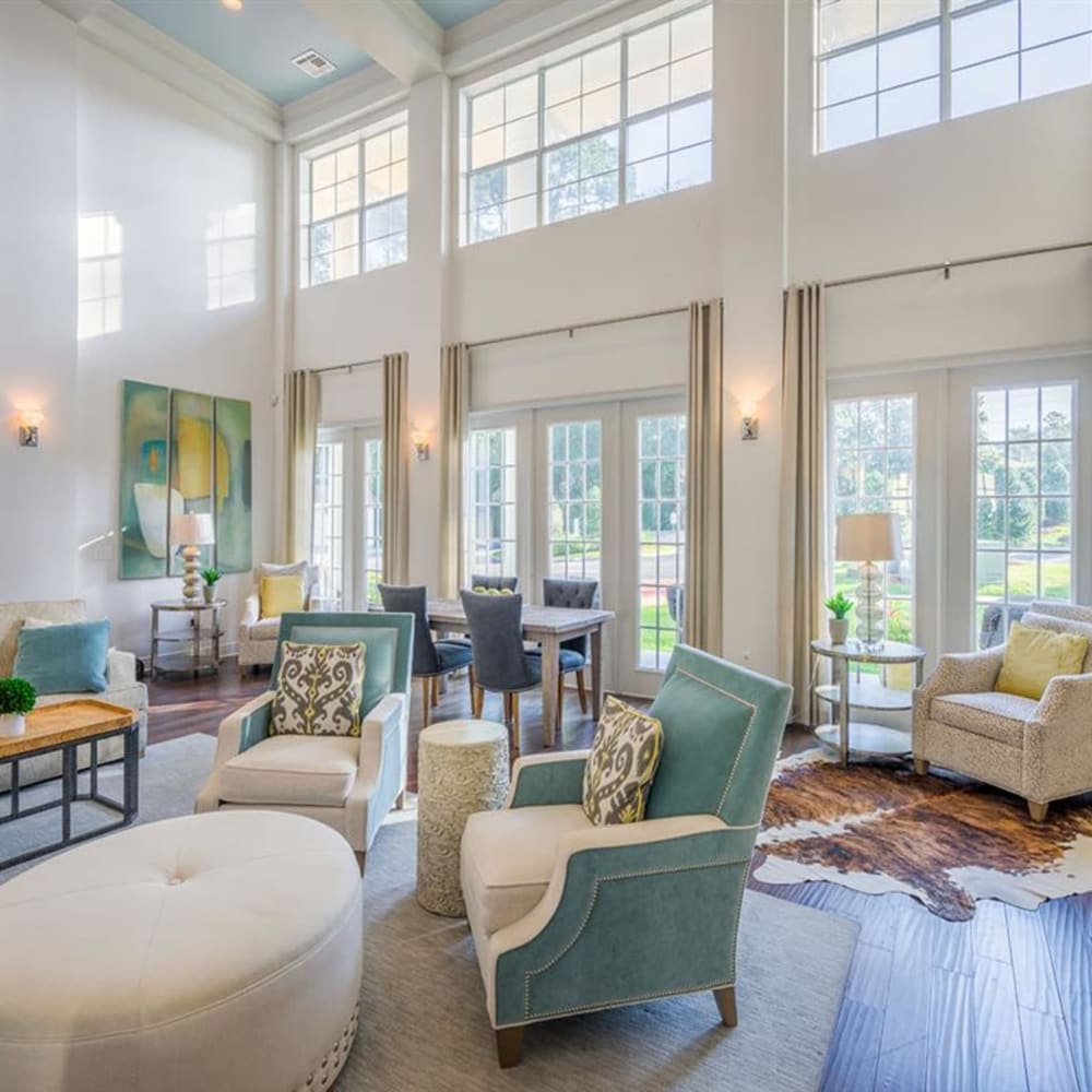 Lounge seating by the windows in the clubhouse at Evergreens at Mahan in Tallahassee, Florida