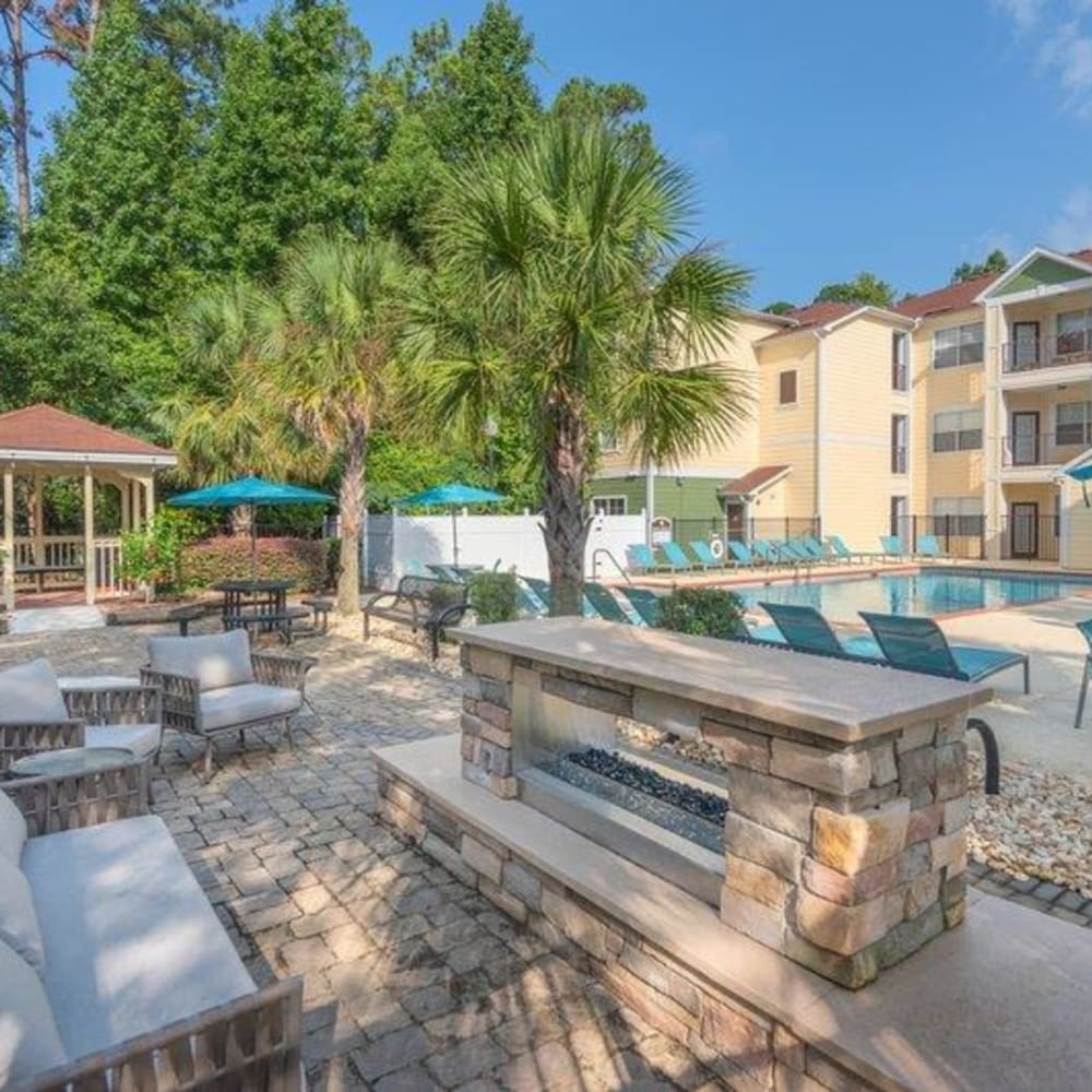 Outdoor fireside seating next to the swimming pool at Evergreens at Mahan in Tallahassee, Florida