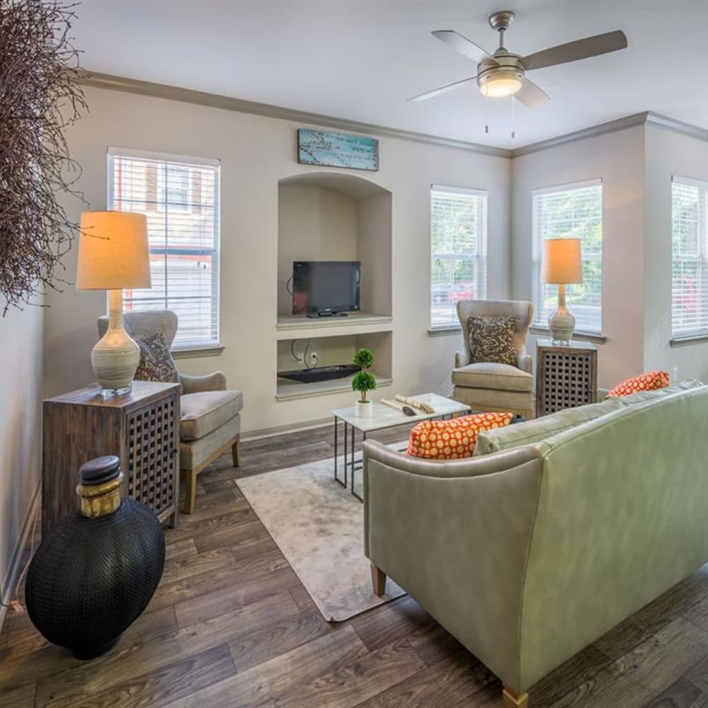 Wood flooring in a furnished apartment living room with built in shelves at Evergreens at Mahan in Tallahassee, Florida