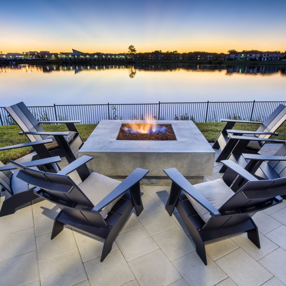 Outdoor fireside seating facing the water for residents at Ravella at Town Center in Jacksonville, Florida