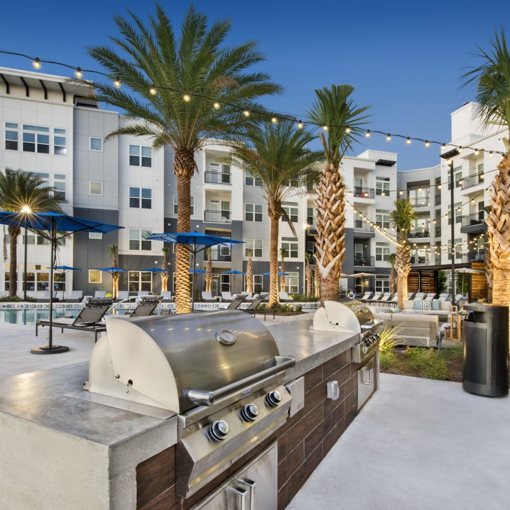 A community grilling station by the swimming pool at Ravella at Town Center in Jacksonville, Florida