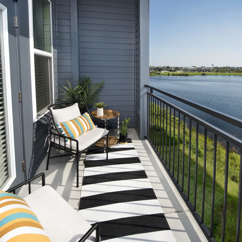 Outdoor seating on an apartment patio at Ravella at Town Center in Jacksonville, Florida