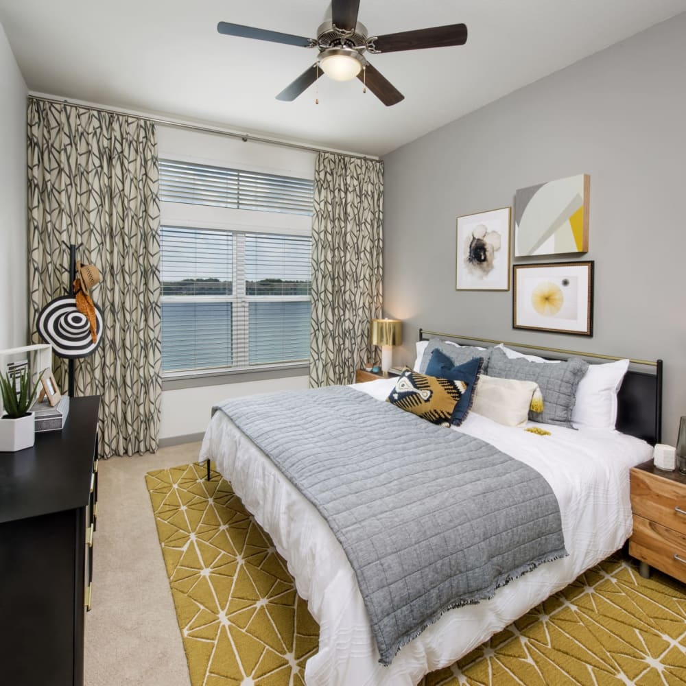 A large bed in a furnished bedroom at Ravella at Town Center in Jacksonville, Florida
