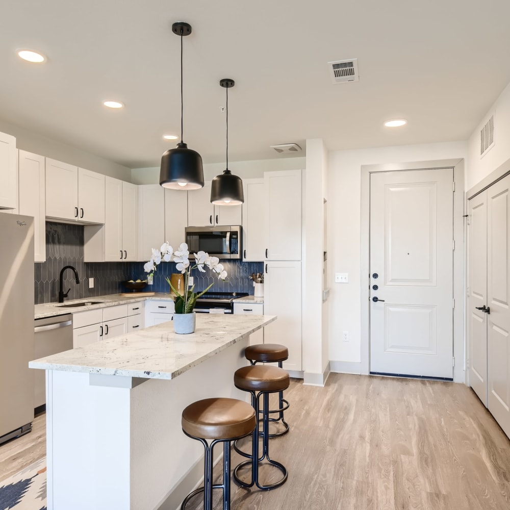 Bar seating at a kitchen island in an apartment at Cypress McKinney Falls in Austin, Texas