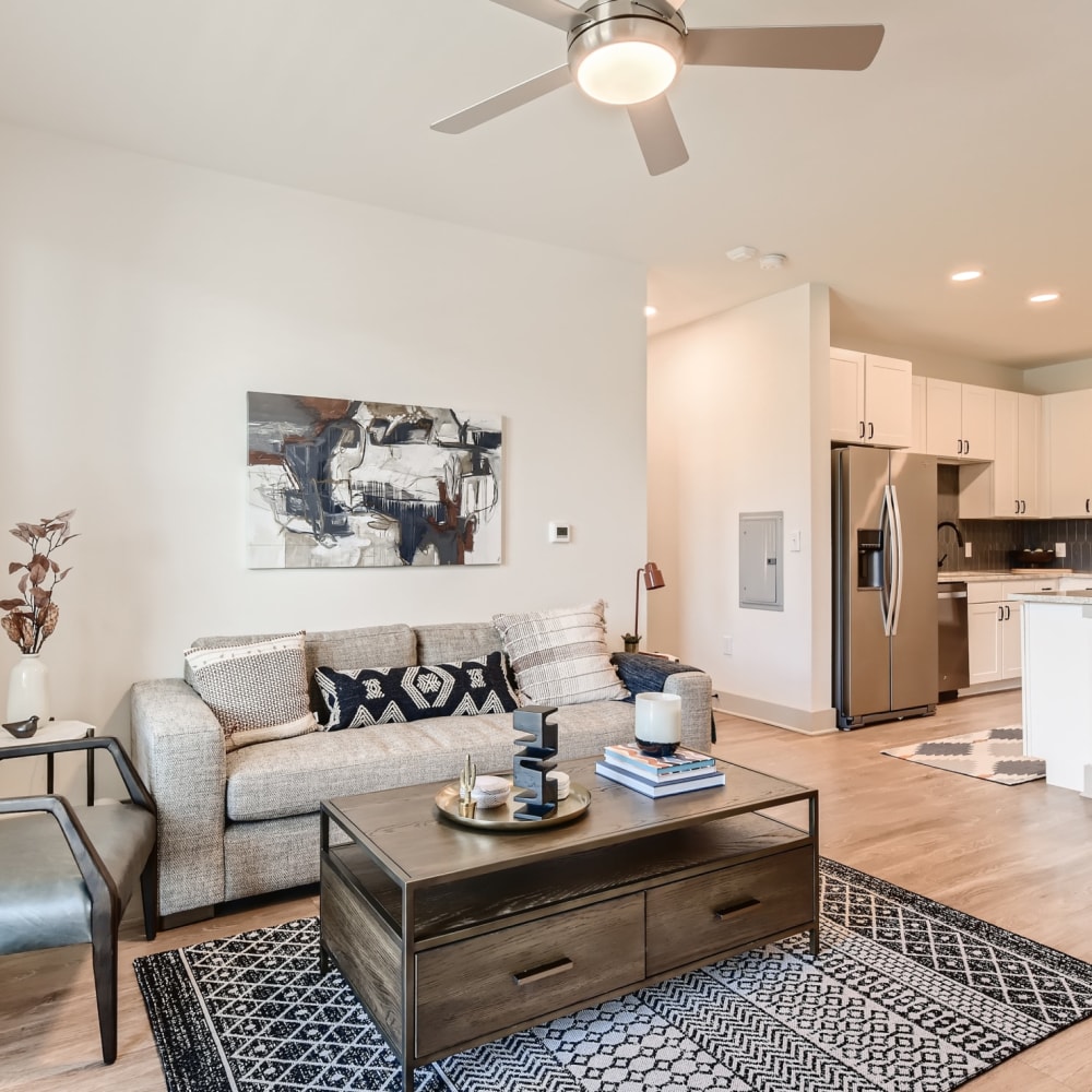 Wood flooring in a furnished apartment living room and kitchen at Cypress McKinney Falls in Austin, Texas