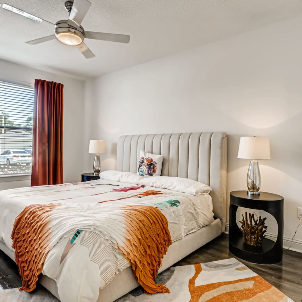 A furnished apartment bedroom with a ceiling fan at EOS in Orlando, Florida