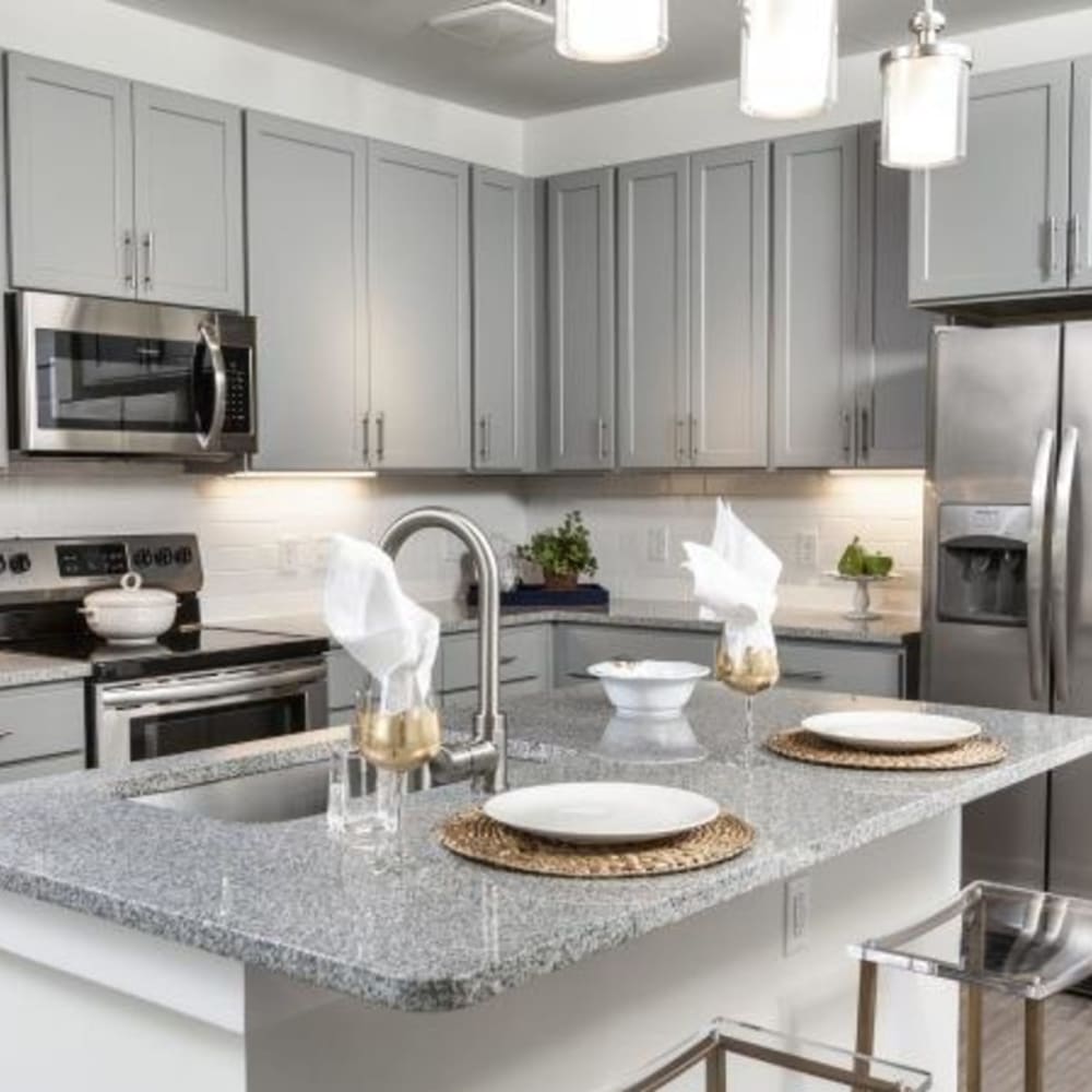 Bar seating and stainless steel appliances in an apartment kitchen at Retreat at Fairhope Village in Fairhope, Alabama