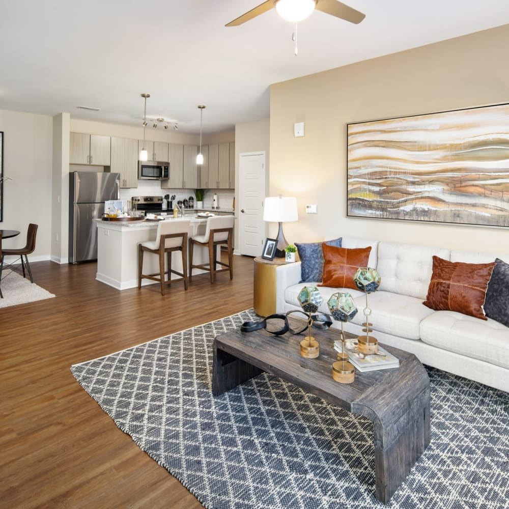 A model apartment living room, dining room and kitchen at The Alexandria in Madison, Alabama