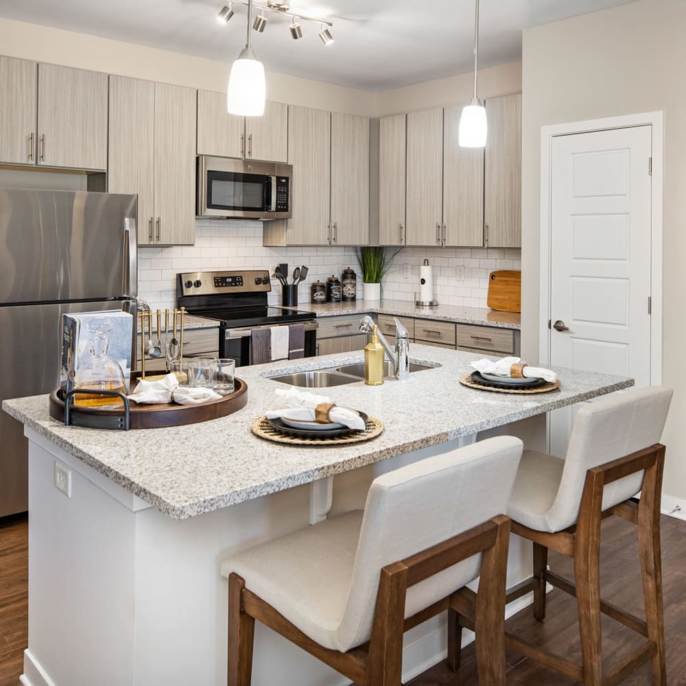 Bar seating at a kitchen island in an apartment at The Alexandria in Madison, Alabama