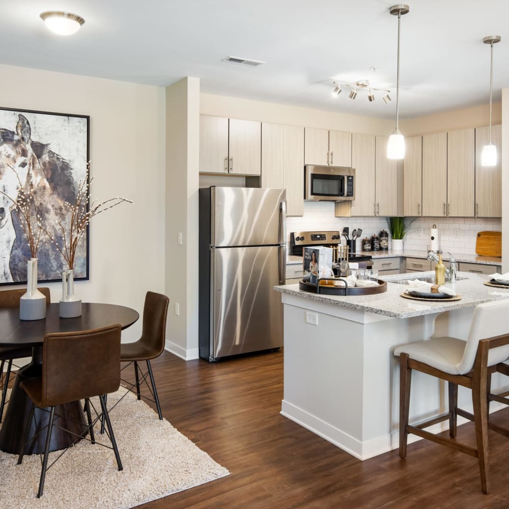 A furnished apartment dining room and kitchen at The Alexandria in Madison, Alabama