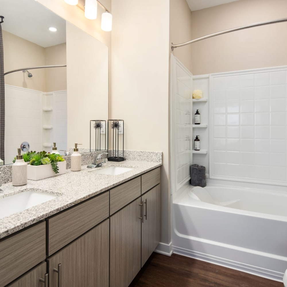 A double sink and a tub in an apartment bathroom at The Alexandria in Madison, Alabama