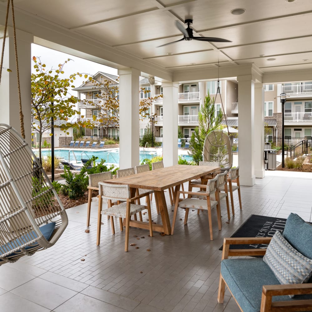 Covered outdoor seating by the community swimming pool at The Highland in Augusta, Georgia