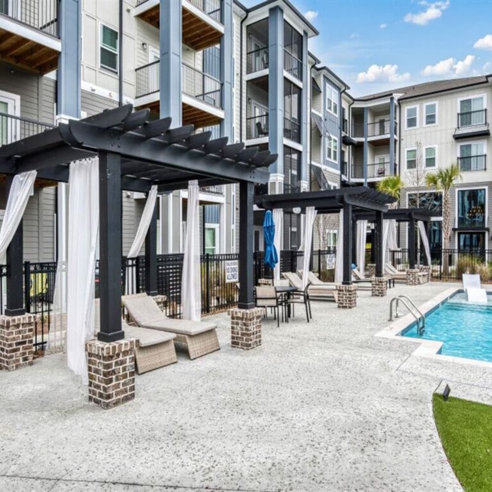 Covered outdoor seating by the swimming pool at The Lively Indigo Run in Ladson, South Carolina