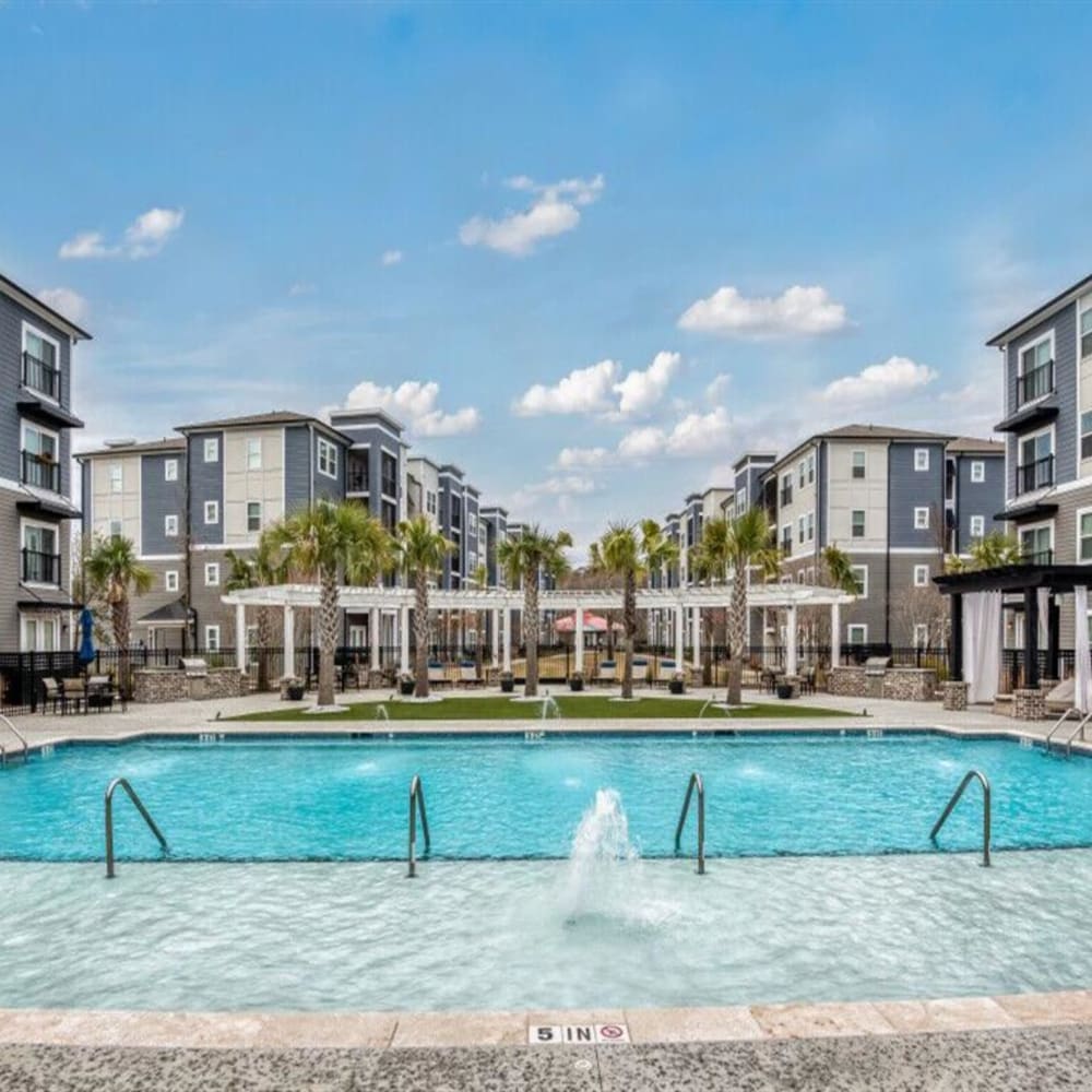 The community pool surrounded by apartments at The Lively Indigo Run in Ladson, South Carolina