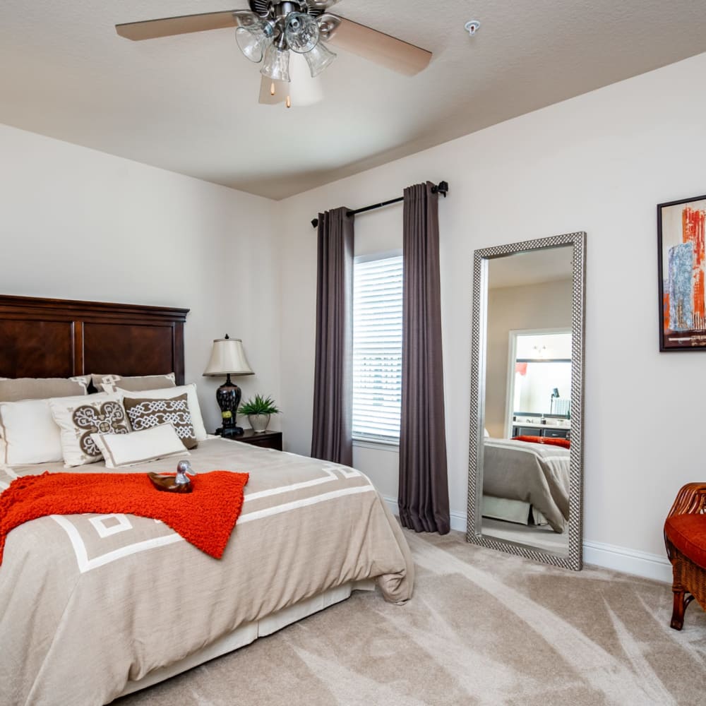 A furnished apartment bedroom with plush carpeting at Riverstone in Macon, Georgia