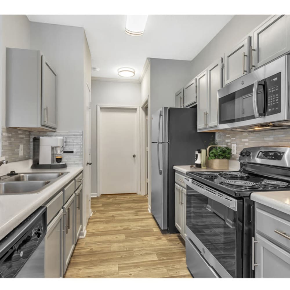 A modern apartment kitchen with upgraded appliances at Astoria in Mobile, Alabama