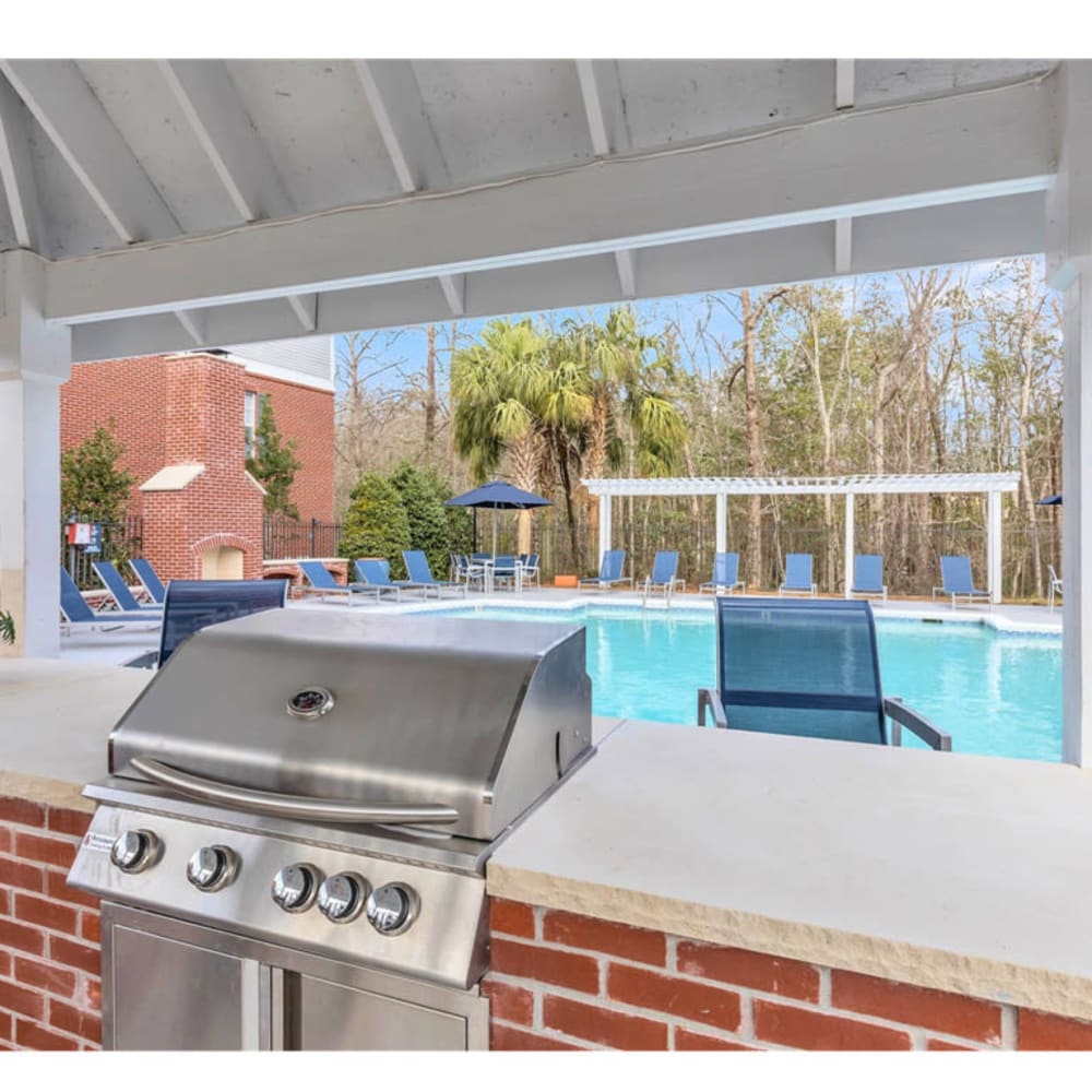 An outdoor grilling station next to the community swimming pool at Astoria in Mobile, Alabama