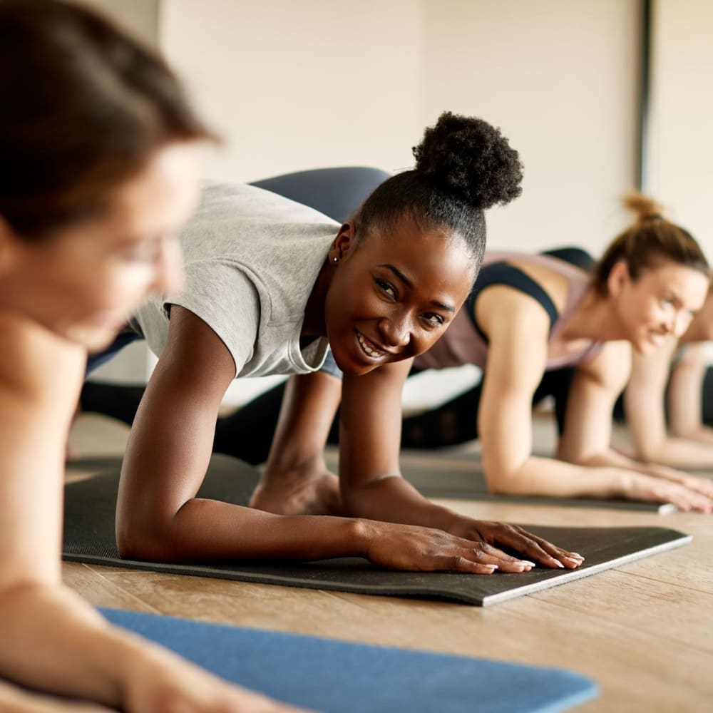 Residents enjoying yoga at Avemore Apartment Homes in Charlottesville, Virginia