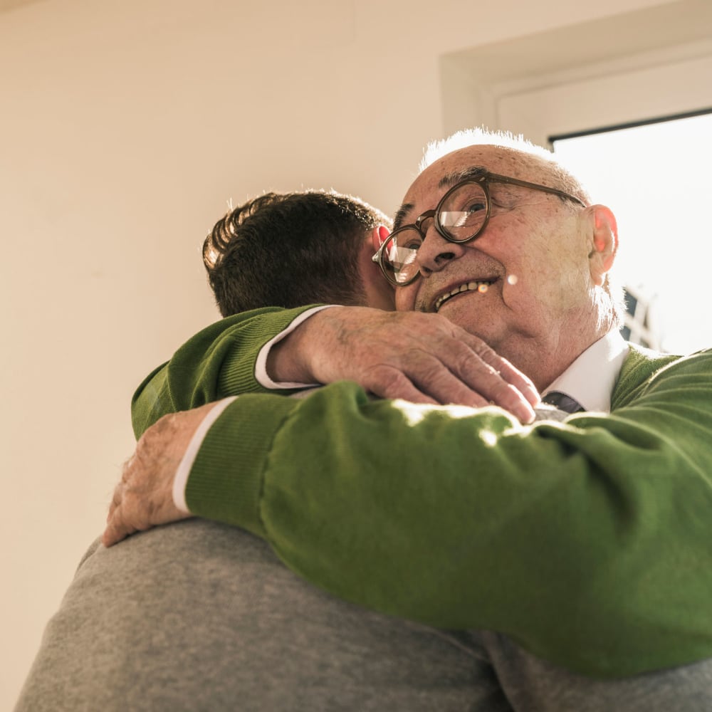 Two smiling residents at The Peaks at Clinton Memory Care in Clinton, Utah