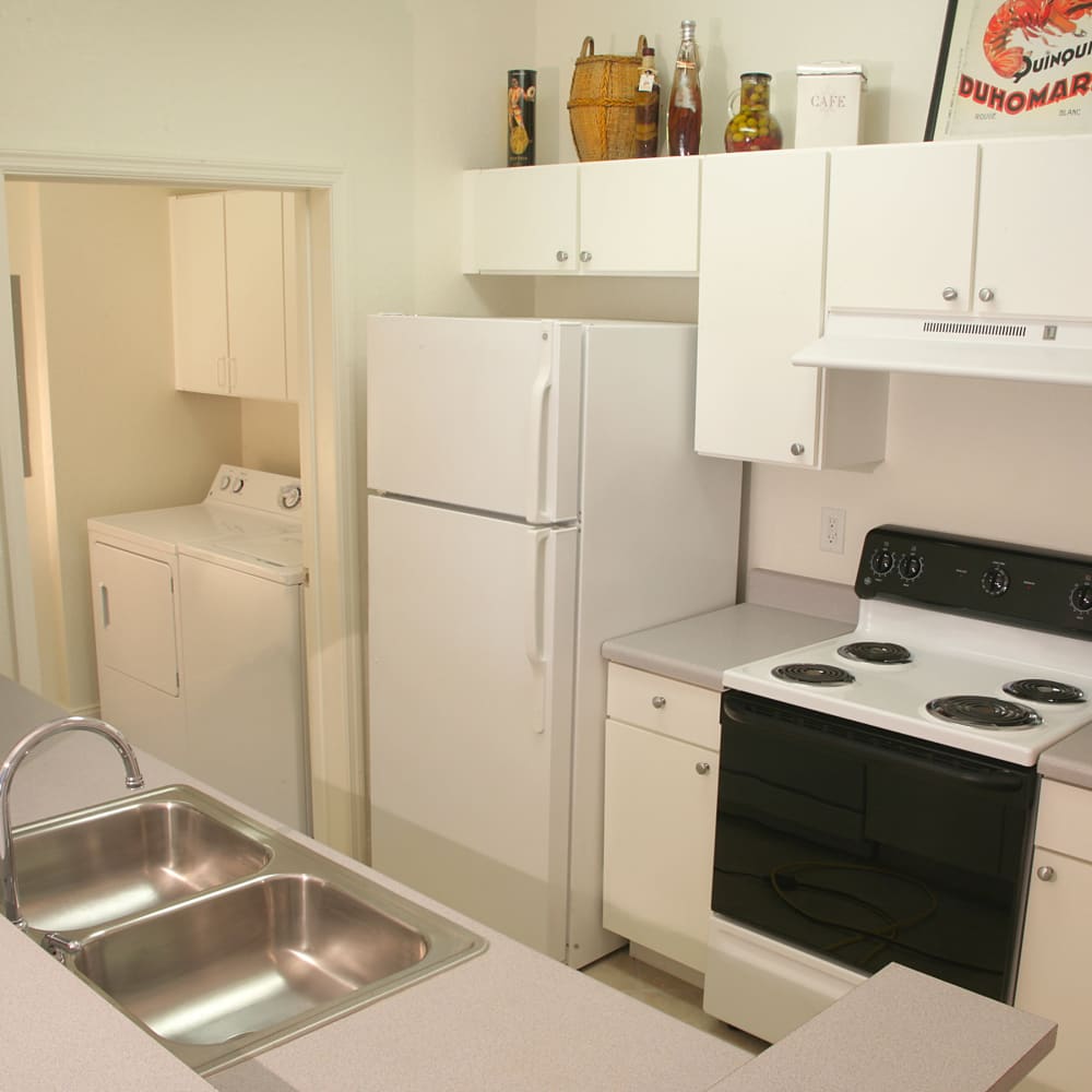 Kitchen with white cabinet at Beachside Apartments in Satellite Beach, Florida
