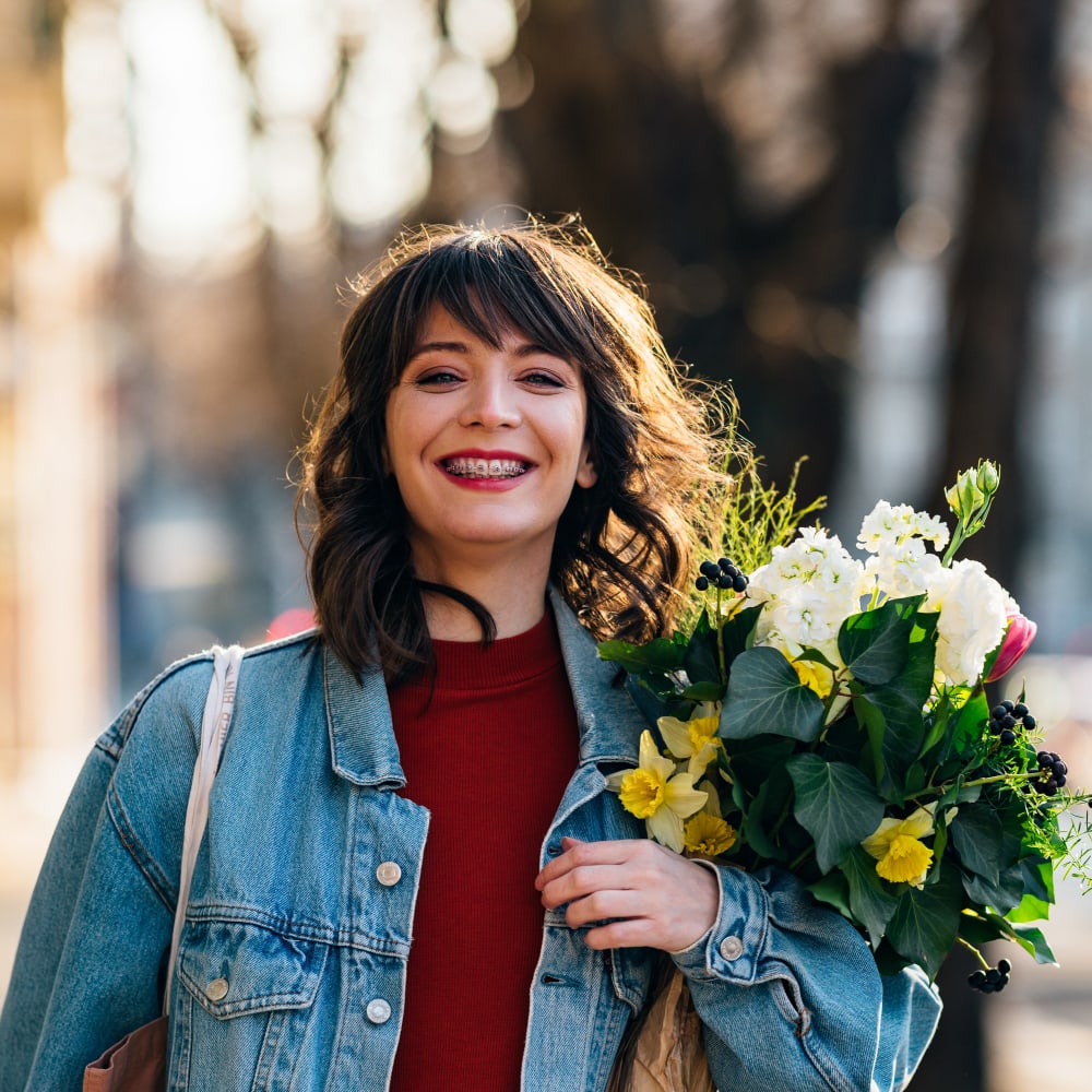Woman with flowers near 678 Bellflower in Sunnyvale, California