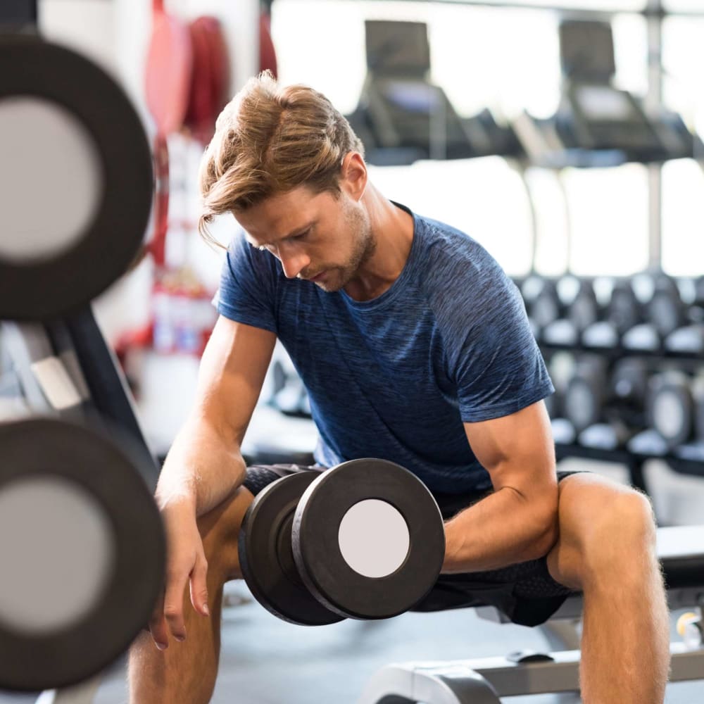 Resident working out in the fitness center at The Gates in Houston, Texas