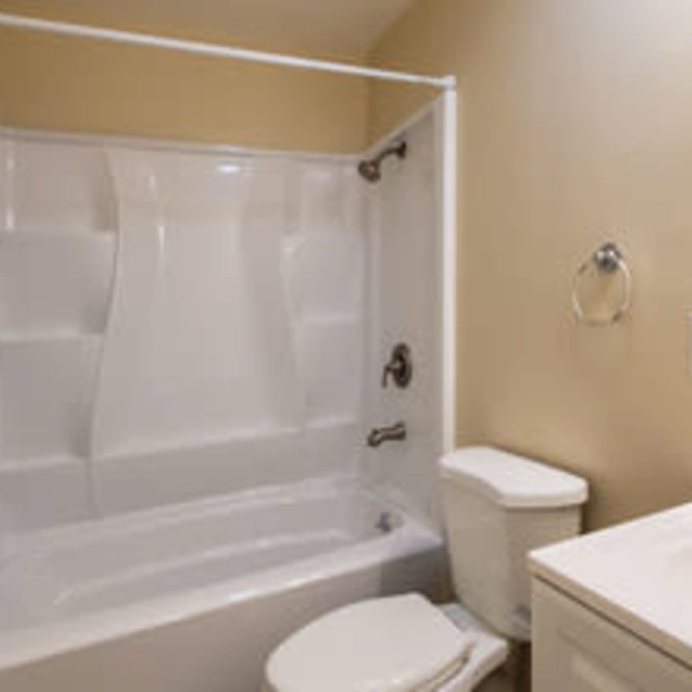 Garden tub and toilet in an apartment's bathroom at our Heights at 109 community at Mission Rock at Novato in Novato, California