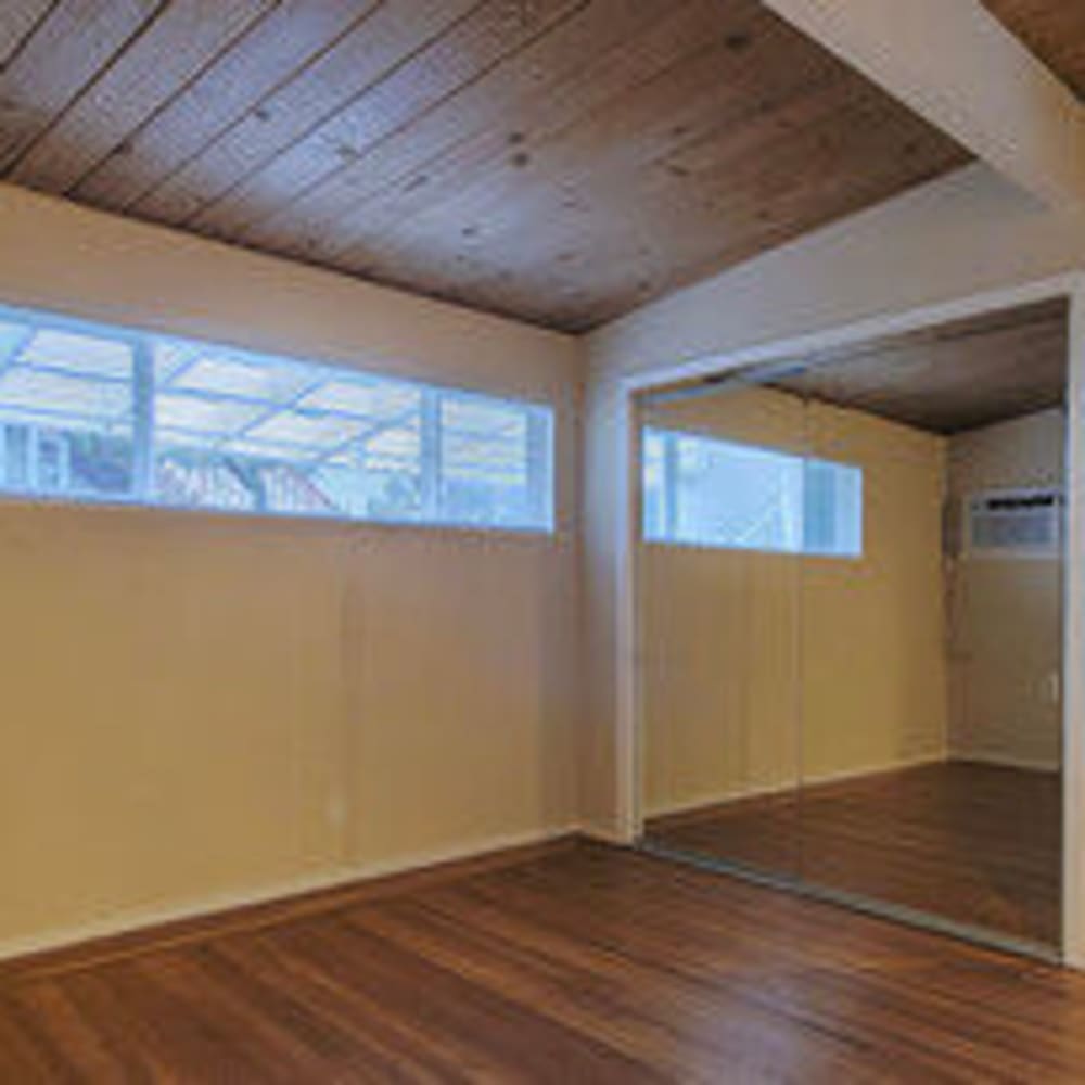 Bedroom with featured wood ceiling and large closet in an apartment home at our Glenwood community at Mission Rock at Novato in Novato, California