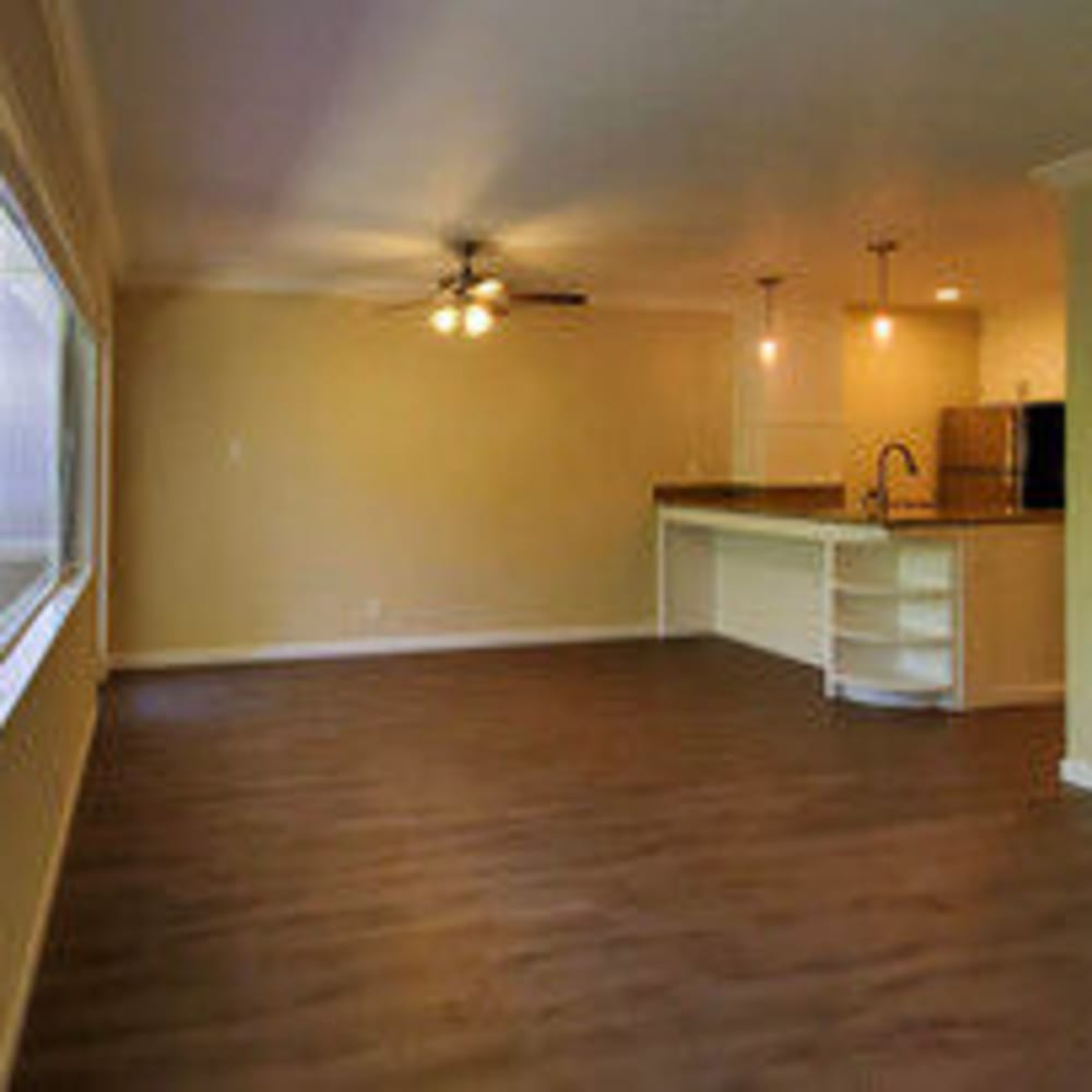 Open concept living room with ceiling fan in an apartment at our Glenwood community at Mission Rock at Novato in Novato, California