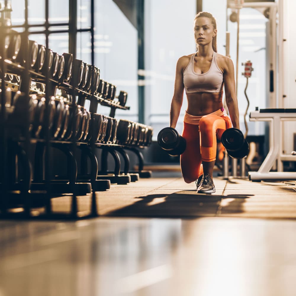 Resident working out in the fitness center at The Domain at Ellington in Houston, Texas