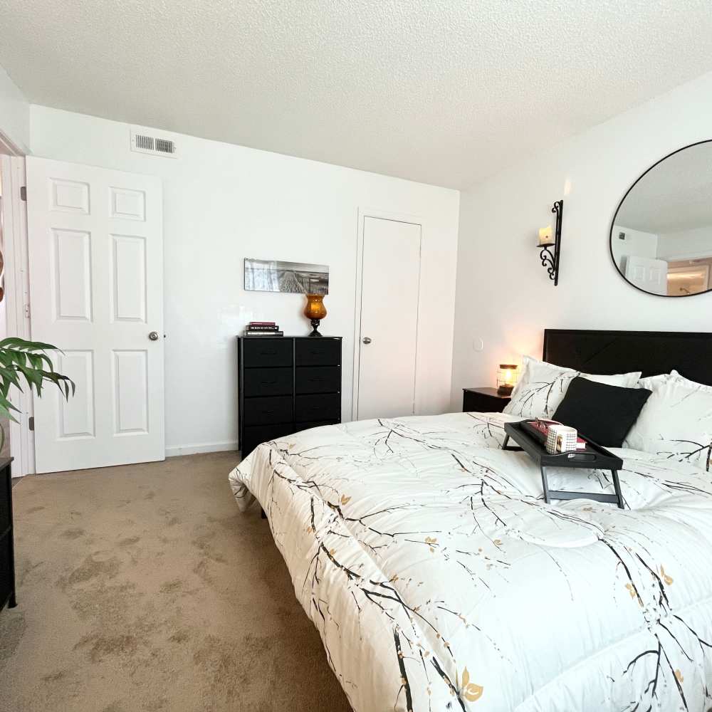 Bedroom with plush carpeting at Autumn Ridge Apartments in Suffolk, Virginia