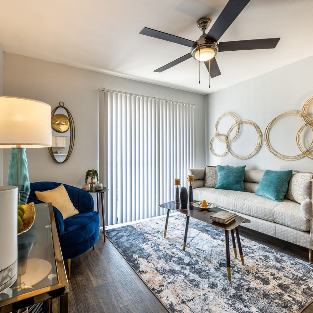 Resident living room with couch and rug at The Grove in Houston, Texas