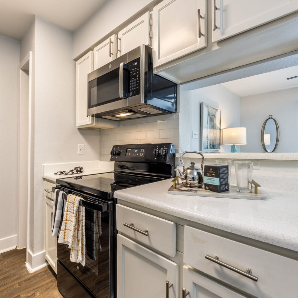 Kitchen with wood-style flooring at The Grove in Houston, Texas