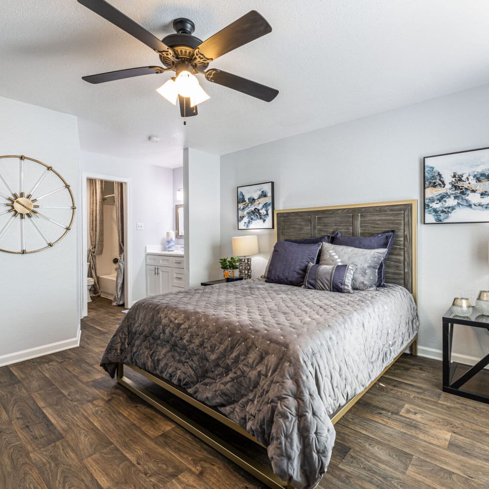Beautiful bedroom with wood-style flooring at The Linc at Cypress in Houston, Texas