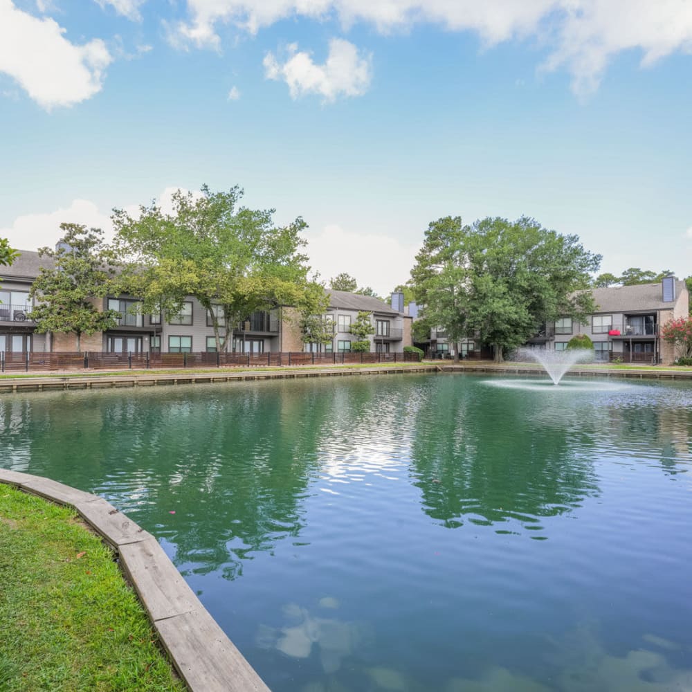 Large body of water featuring water works at Lakebridge Apartments in Houston, Texas