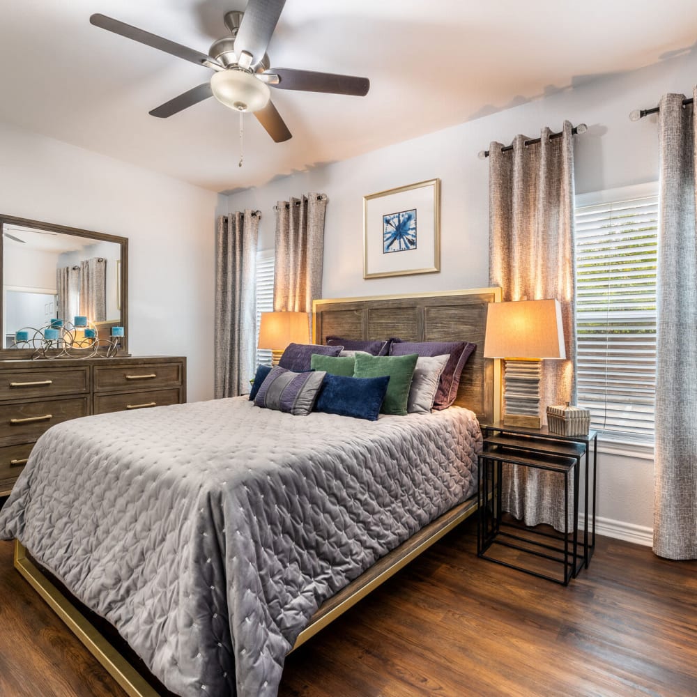 Resident bedroom with wood-style flooring at Lakebridge Apartments in Houston, Texas