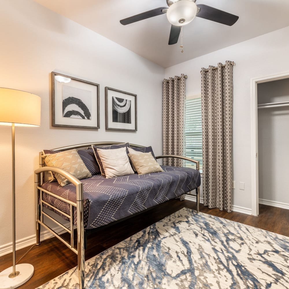 Resident bedroom with ceiling fan at Lakebridge Apartments in Houston, Texas