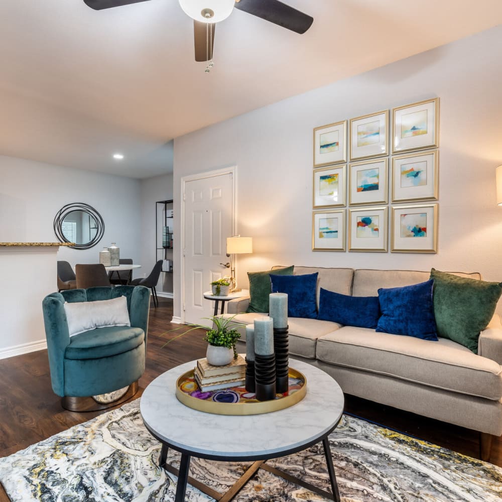 Living space with wood-style flooring and a couch and coffee table at Lakebridge Apartments in Houston, Texas