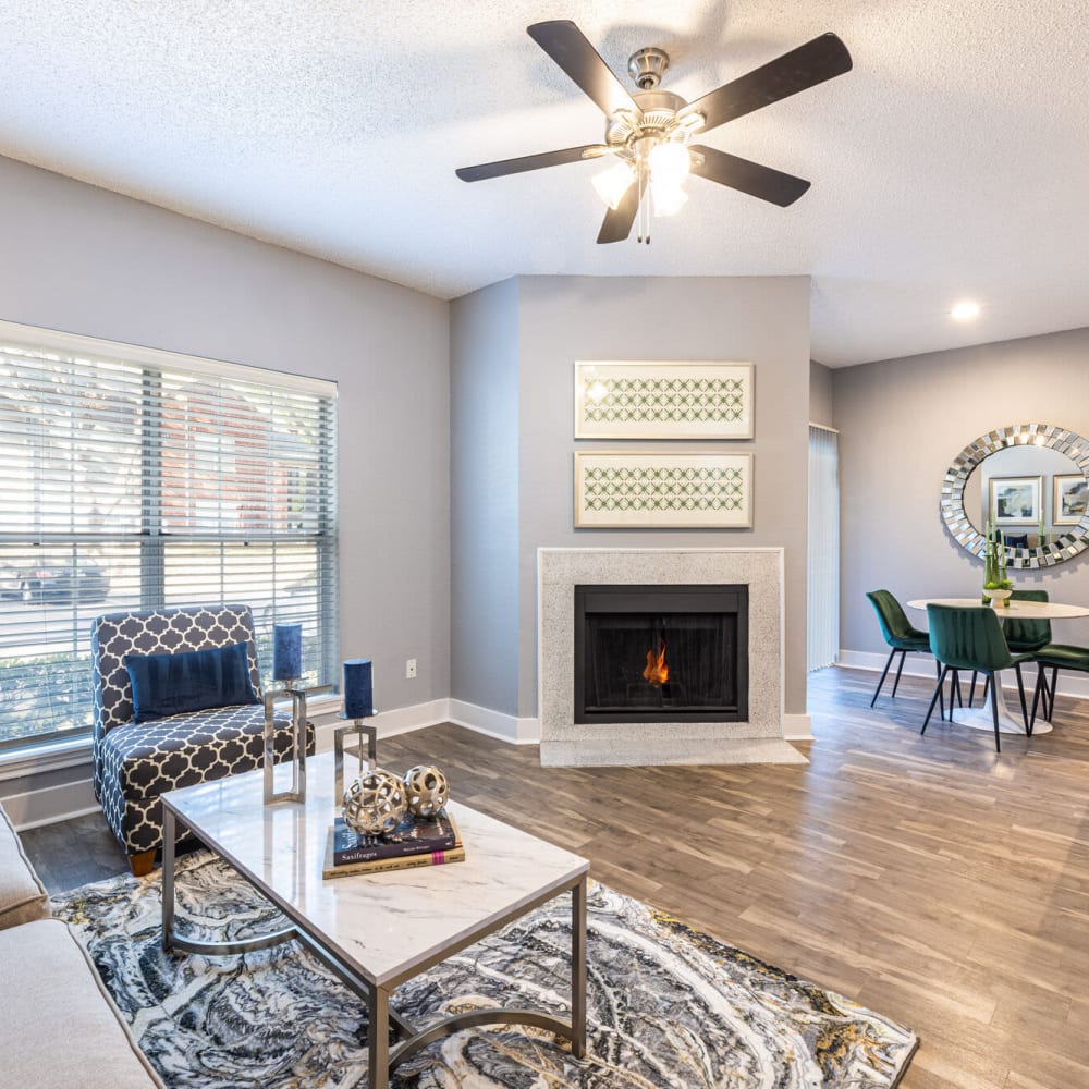 Open spacious living room with a fireplace at The Bradford on the Park in Bedford, Texas