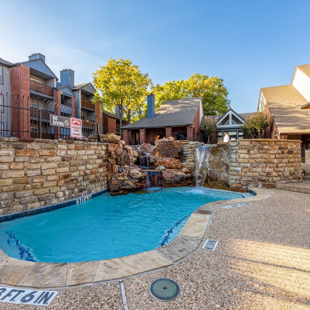 Refreshing pool with water feature at The Bradford on the Park in Bedford, Texas