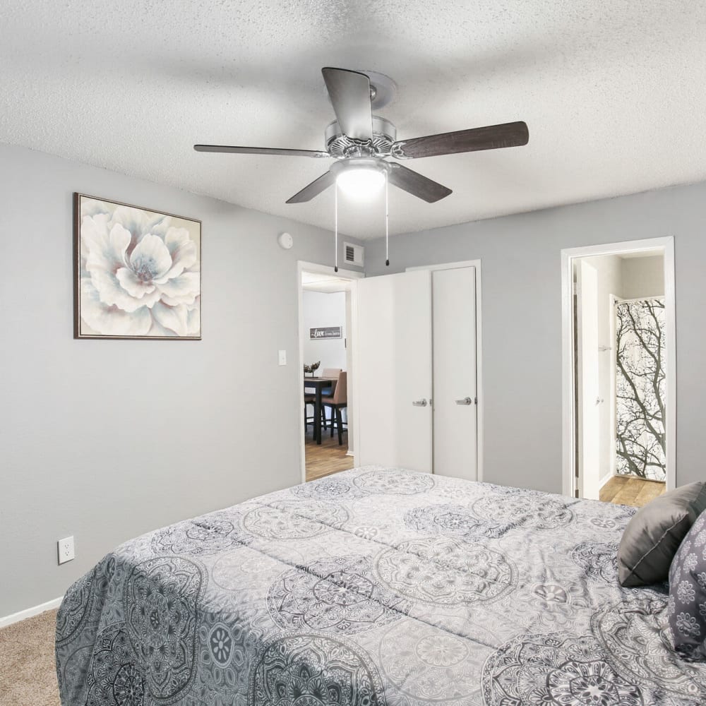 Resident bedroom with ceiling fan at The District on Collins in Arlington, Texas