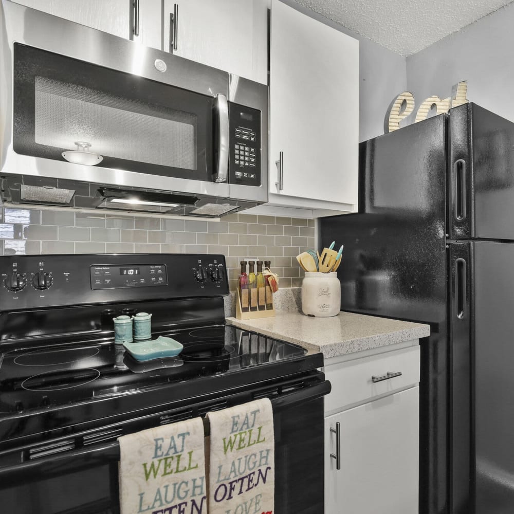 Kitchen with modern appliances at TwentyOne15 in Arlington, Texas