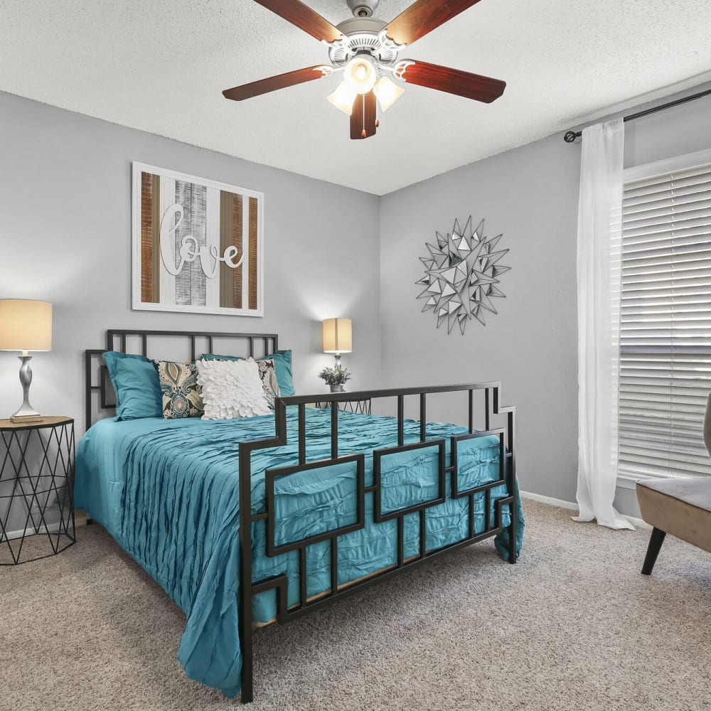 Bedroom with plush carpeting at TwentyOne15 in Arlington, Texas