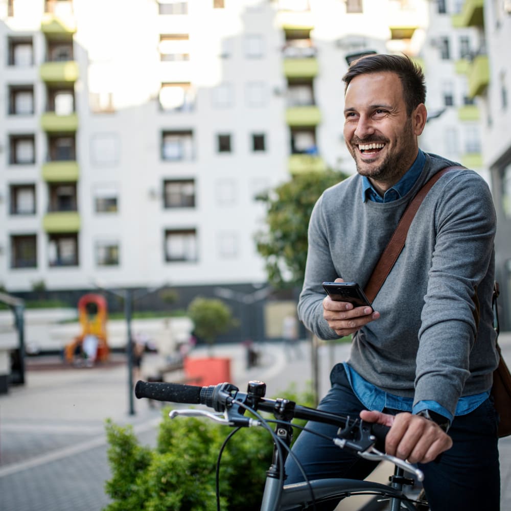 A smiling man on his bike in the city near Dolphin Marina Apartments in Marina Del Rey, California