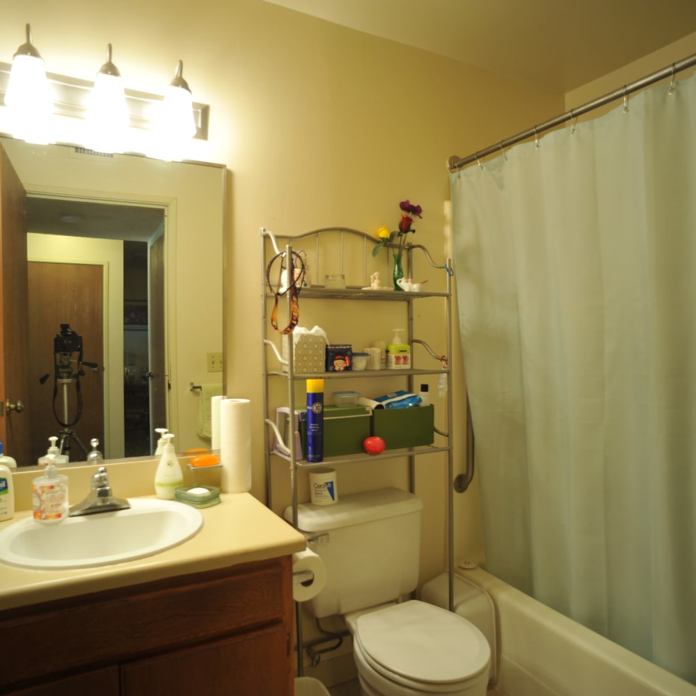 Bathroom with a vanity and tub/shower combination in a model home at Glendora Gardens in Glendora, California