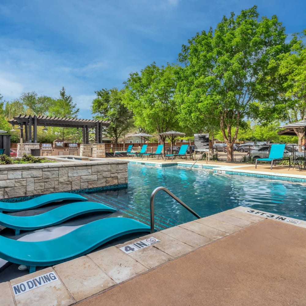 Luxurious inground pool with lounge chairs at Bellrock Bishop Arts in Dallas, Texas