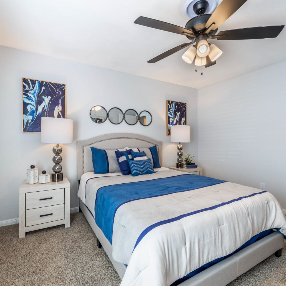 Bedroom with ceiling fan and ample natural light at The Beverly at Clear Lake in Houston, Texas
