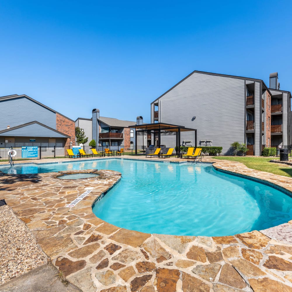 Resort-style pool with barbeque area at The Beverly at Clear Lake in Houston, Texas